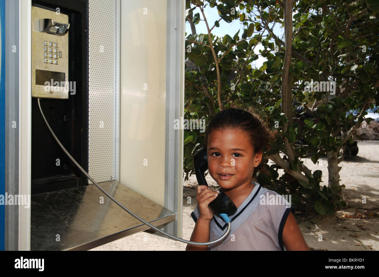 Curacao, Girl using a public phone Stock Photo