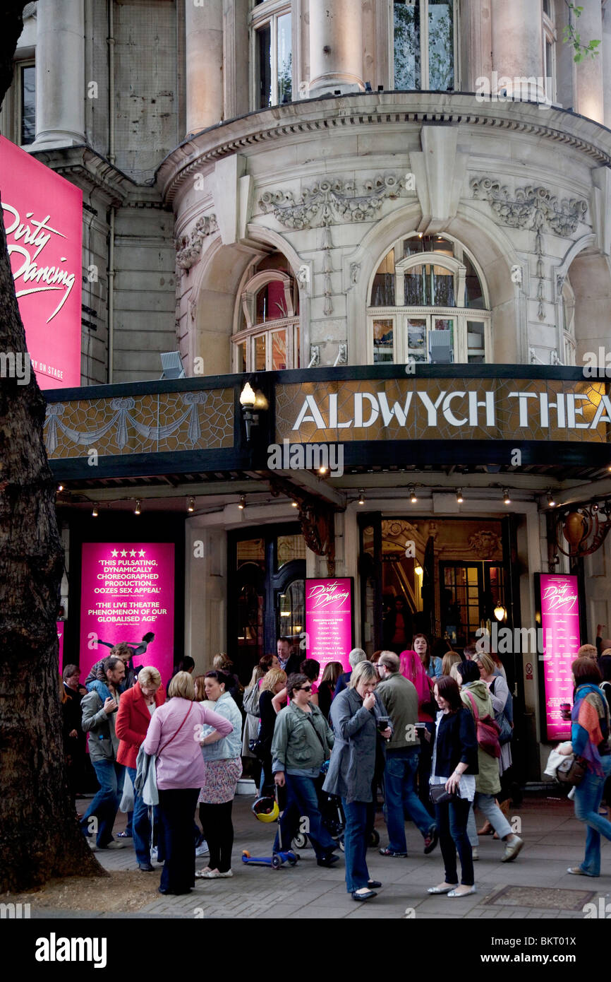 Theatre goers outside the Aldwych Theatre in Covent Garden in the West End of London. The show Dirty Dancing is showing. Stock Photo