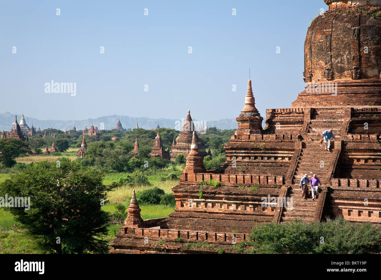 Tourist descending the stirs of Buledi Temple. Bagan. Myanmar Stock Photo