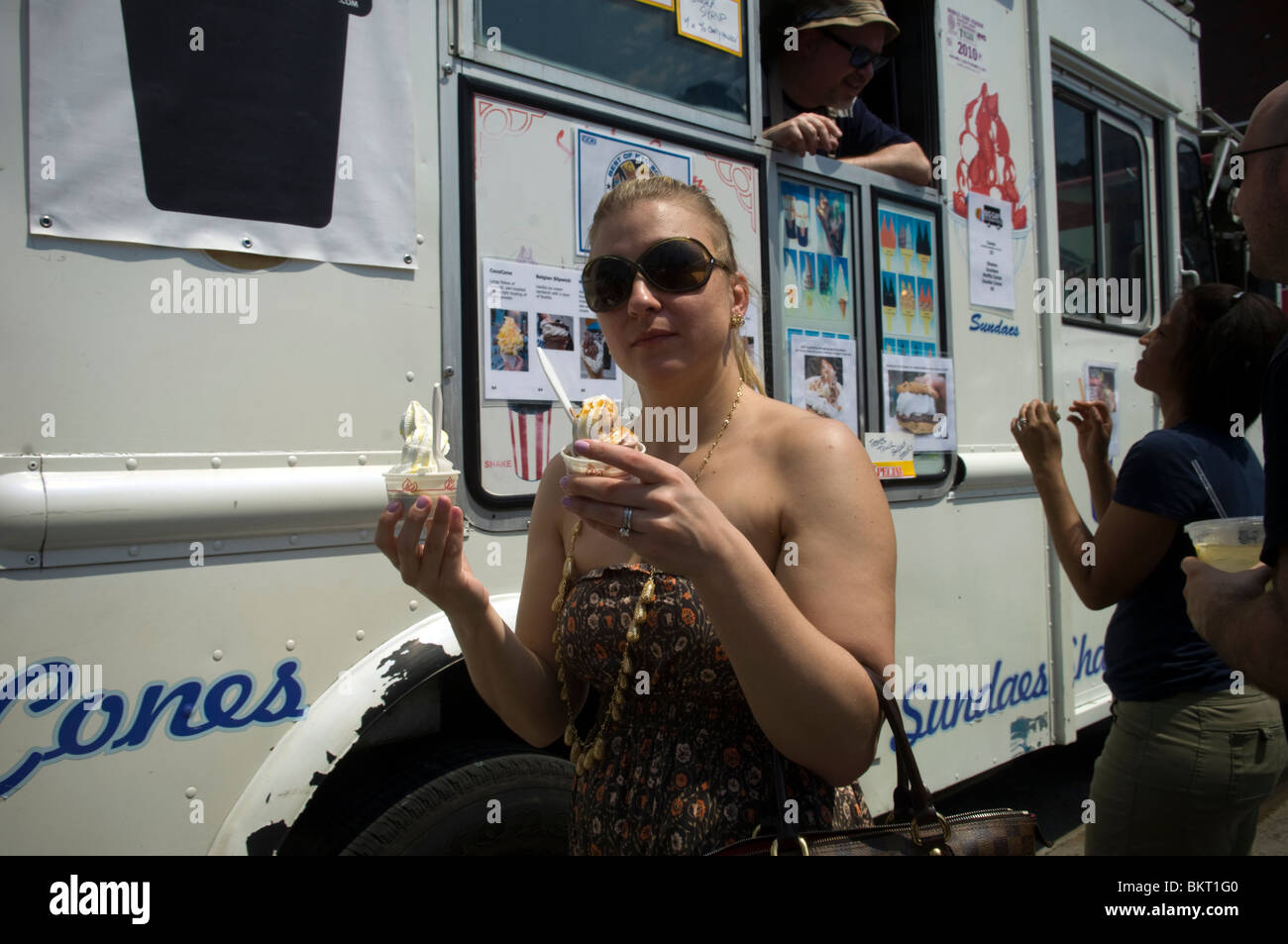 A woman carries ice cream from The Big Gay Ice Cream Truck at the Hell's Kitchen Food Truck Bazaar Stock Photo