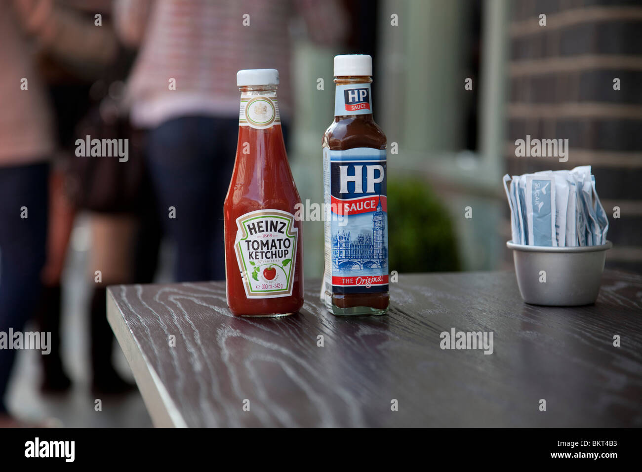 HP Sauce and Heinz Tomato Ketchup bottles outside a cafe. Two icons of the sauce world. Stock Photo