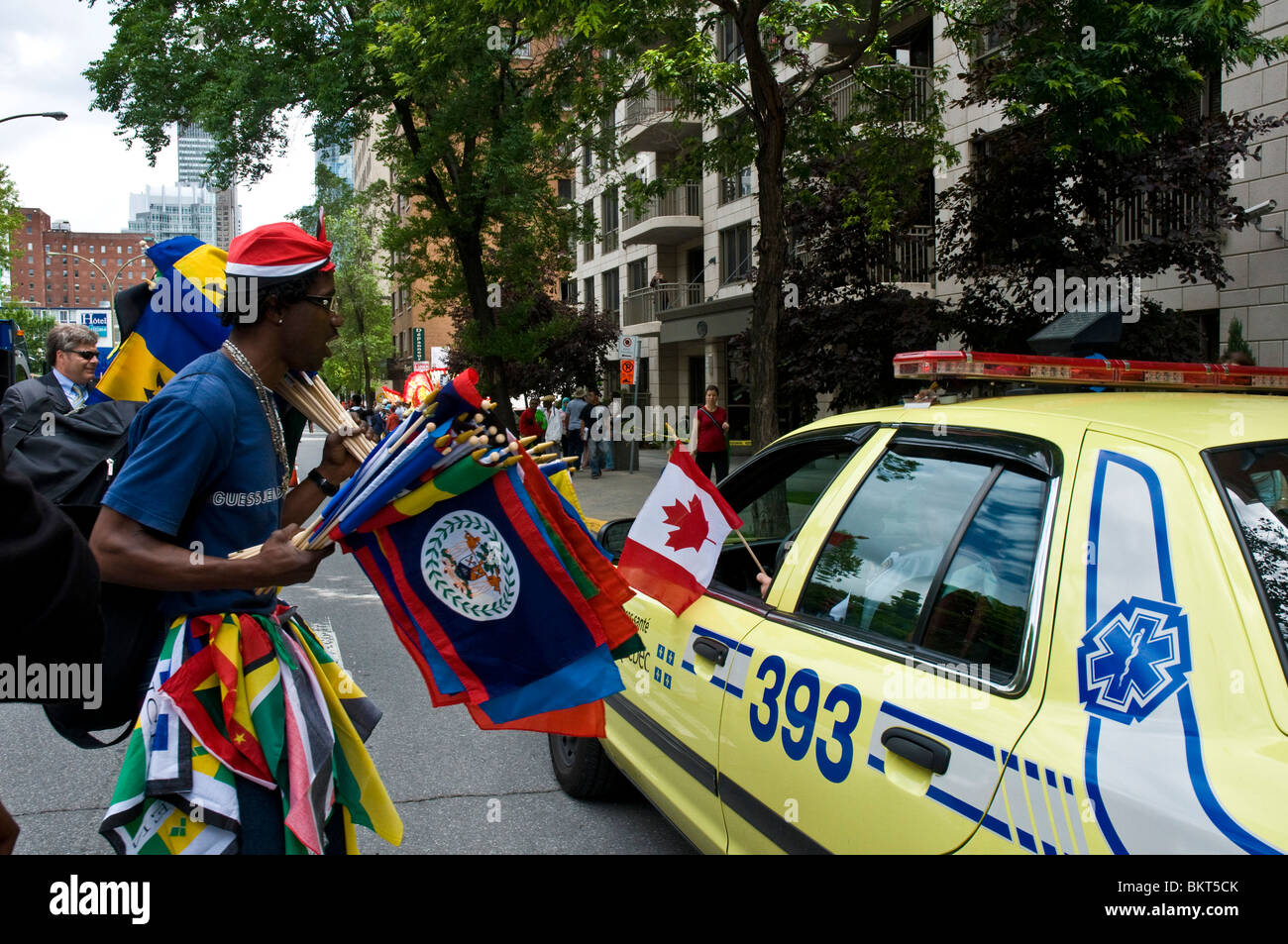 Montrealer selling flags during the Carifete Parade Montreal Stock Photo