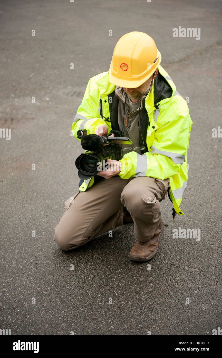 TV news cameraman with hard hat and dayglo PPE Stock Photo