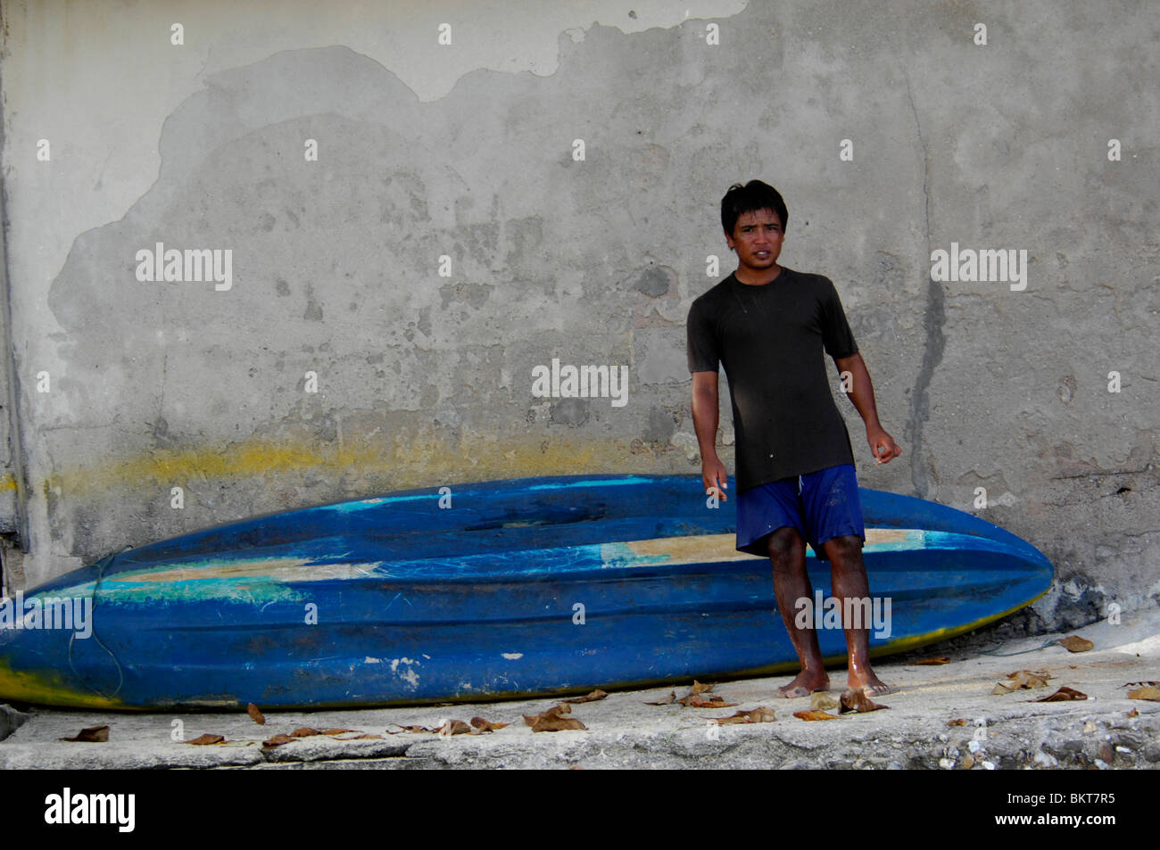 gypsy surfer dude with his board,chao leh, sea gypsy village , rawai beach , phuket island ,thailand Stock Photo