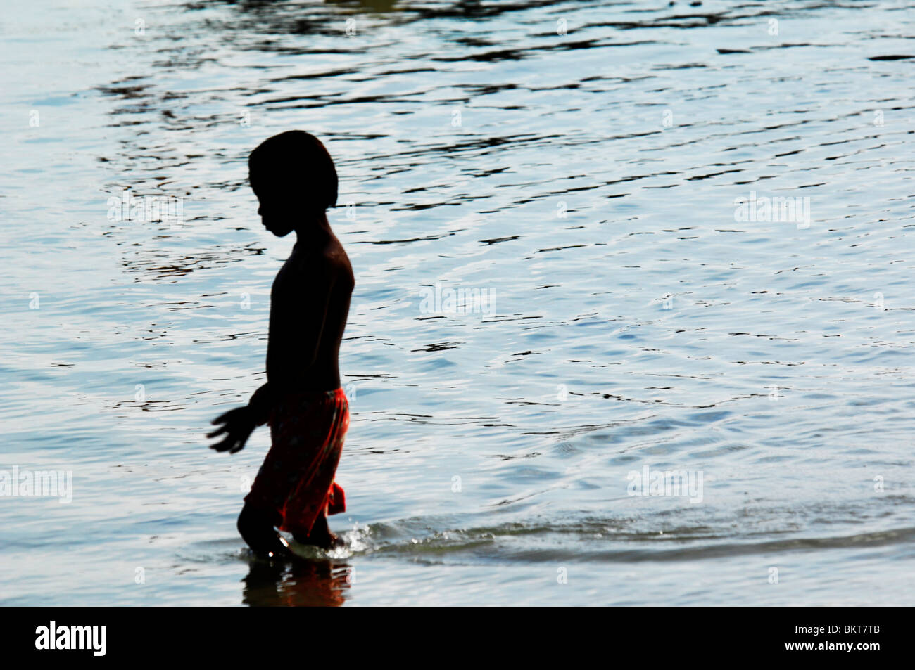 young boy playing in the sea , chao leh, sea gypsy village , rawai beach , phuket island ,thailand Stock Photo