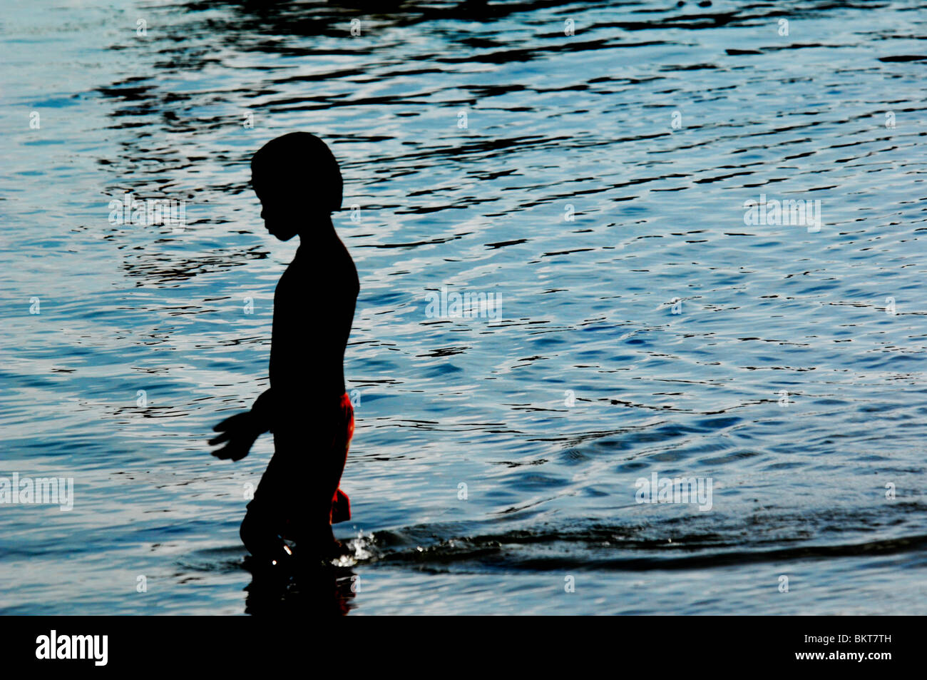 young boy playing in the sea , chao leh, sea gypsy village , rawai beach , phuket island ,thailand Stock Photo