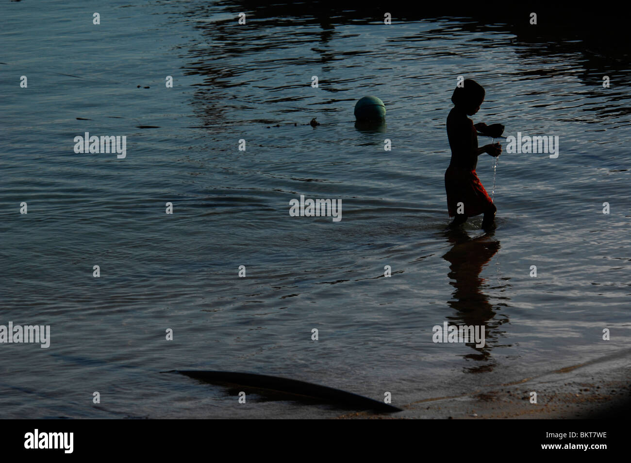 sea gypsy boys playing in the sea,chao leh, sea gypsy village , rawai beach , phuket island ,thailand Stock Photo