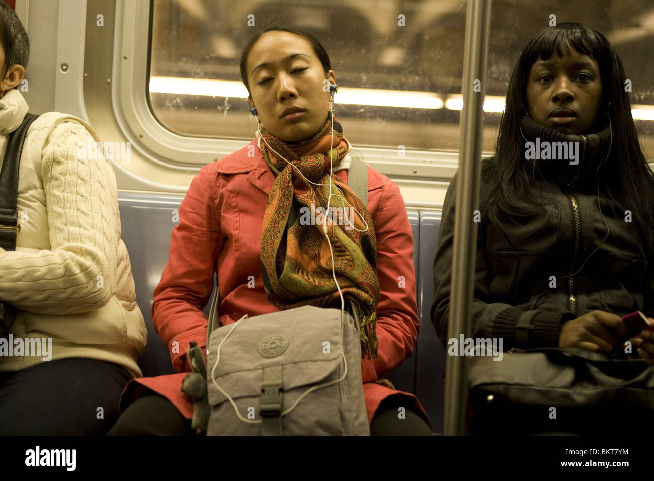 Tired woman on a New York City subway train Stock Photo - Alamy