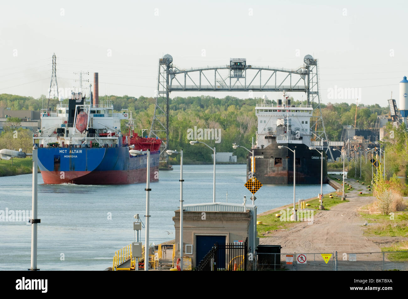 Ships 'MCT Altair' and 'Canadian Enterprise' maneuver around each other in the Welland Canal. Stock Photo