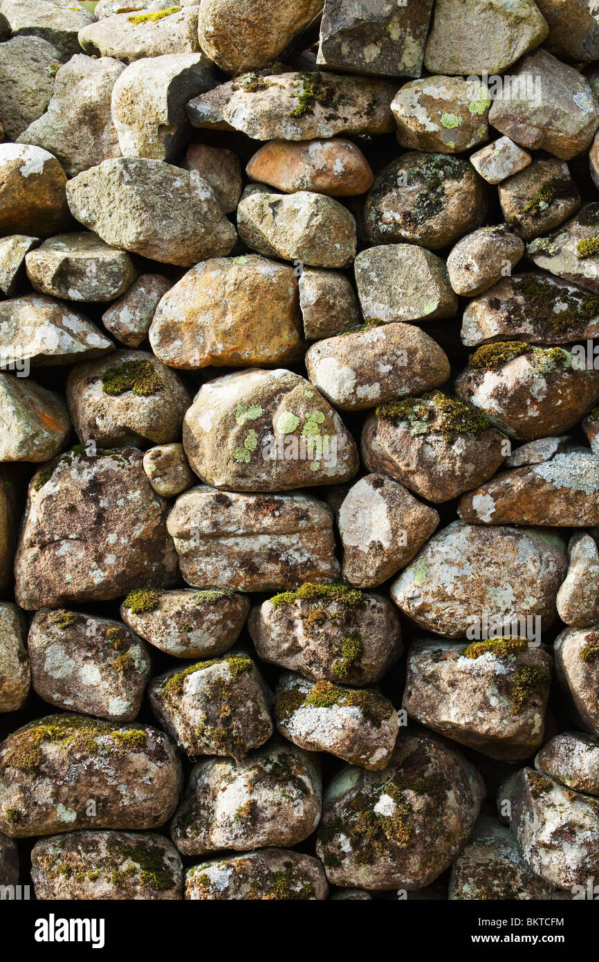 Close up of a dry stone wall, also known as a dry stone dyke, drystane dyke, drystone hedge, or rock fence Stock Photo