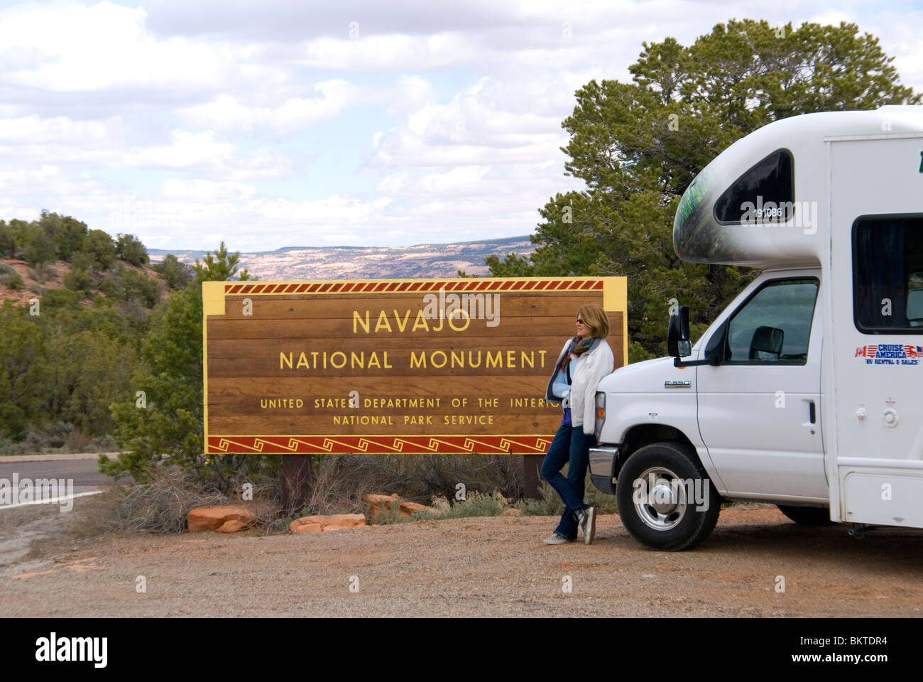 Female tourist leaning on RV campervan at entrance to Navajo National Monument Arizona USA Kim Paumier MR Stock Photo