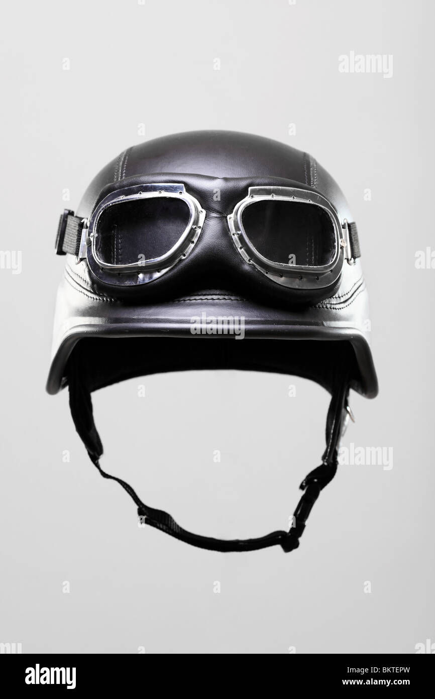 old-style us army motorcycle helmet with goggles, on gray background