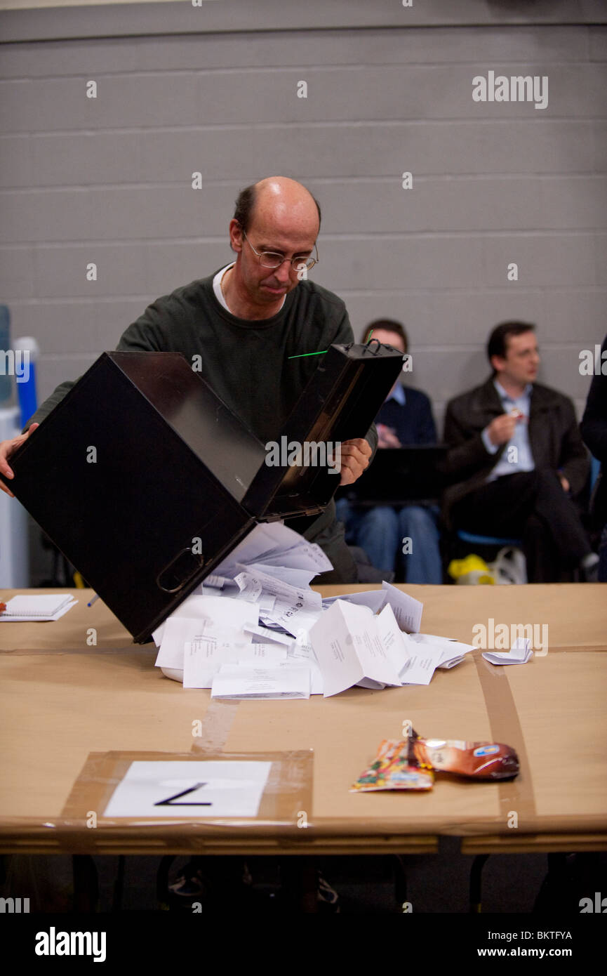 A man emptying the ballot box before counting the votes cast in the Ceredigion constituency at the General Election, May 6 2010 Stock Photo