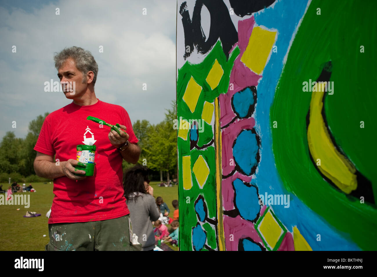 Celebration of World "Fair Trade" Day, with Man Painting Wall, on Lawn