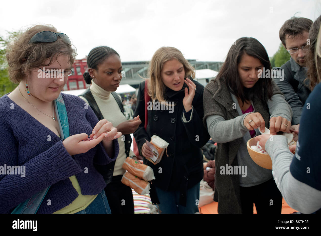 Celebration of World 'Fair Trade' Day, with Fair Trade Cotton Samples, on Lawn of La Villette Park,,medium group of women, diverse people global city Stock Photo