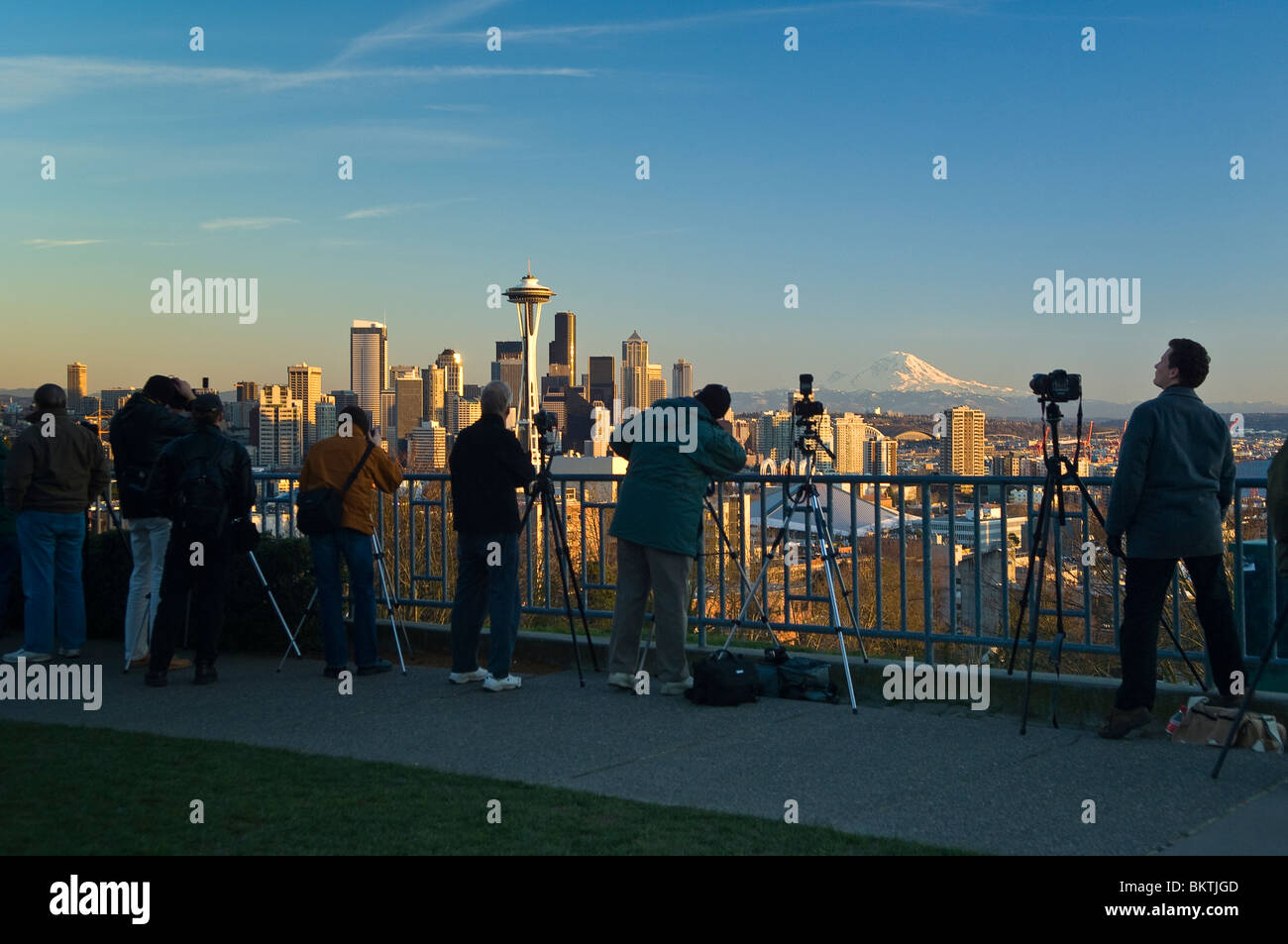 People taking photos of The Space Needle, city skyline and Mount Rainier from Kerry Park on Queen Anne Hill; Seattle, Washington Stock Photo