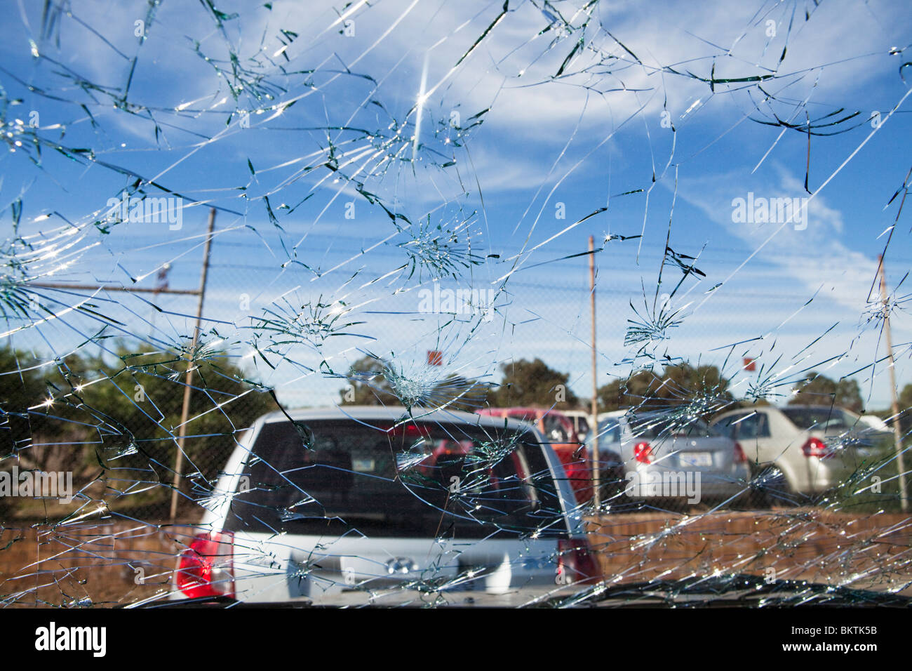 Cracked car windscreen of a car in a car impound full of hail damaged cars from the storm on 22/03/2010 Stock Photo