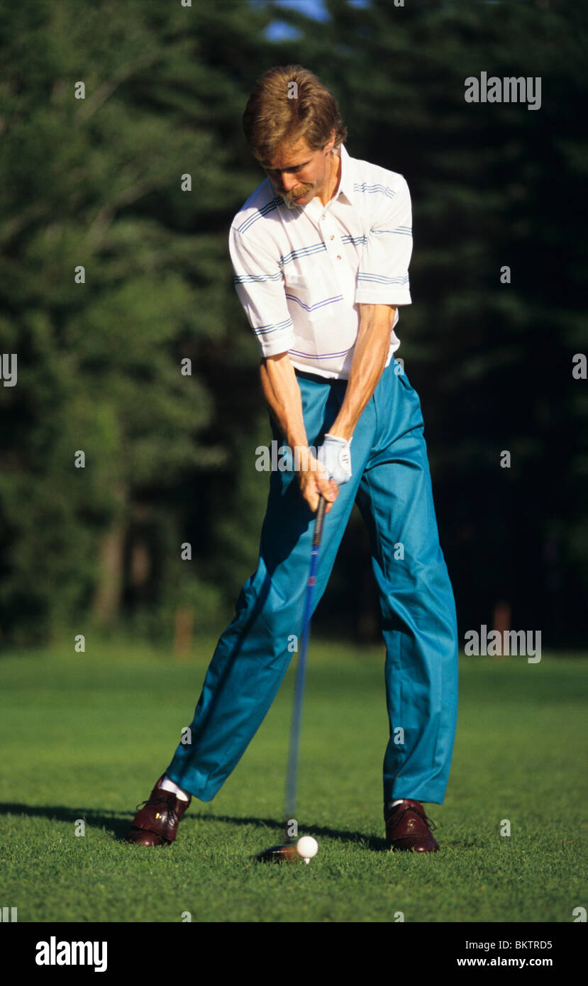 1980's golfer hitting his tee shot. Stock Photo