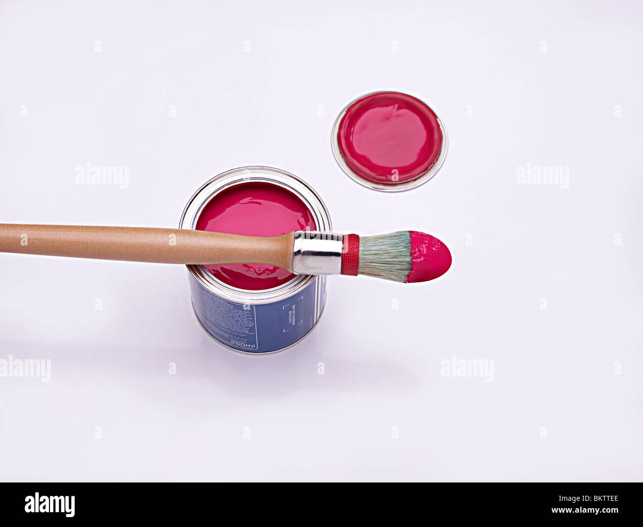 sash paint brush sitting on a pot of red paint Stock Photo