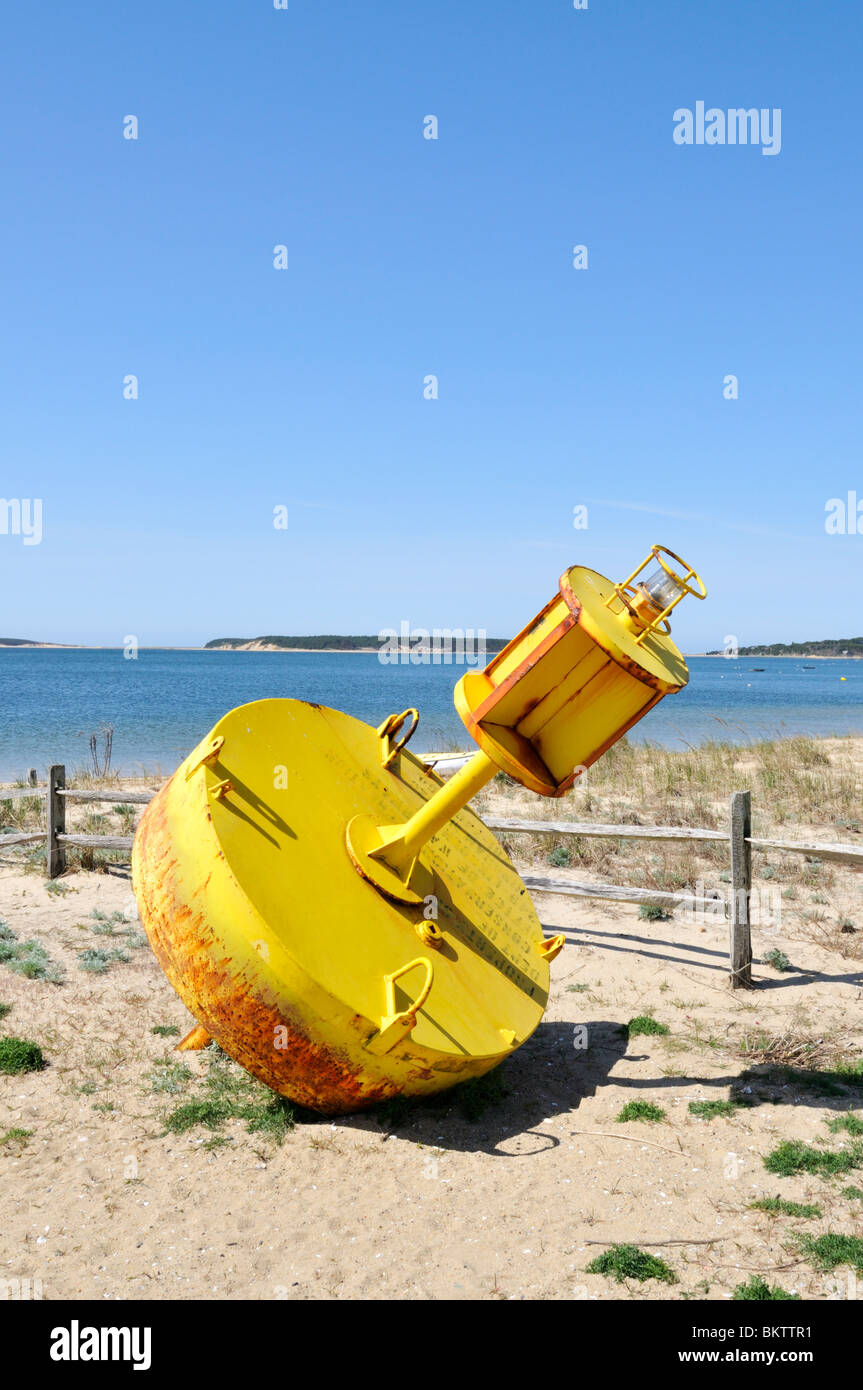 Yellow channel marker on the beach at Wellfleet harbor, Cape Cod