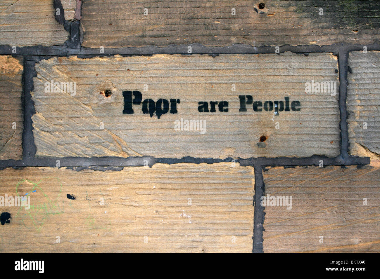 'Poor Are People' Stencil Graffiti In Liverpool, UK Stock Photo