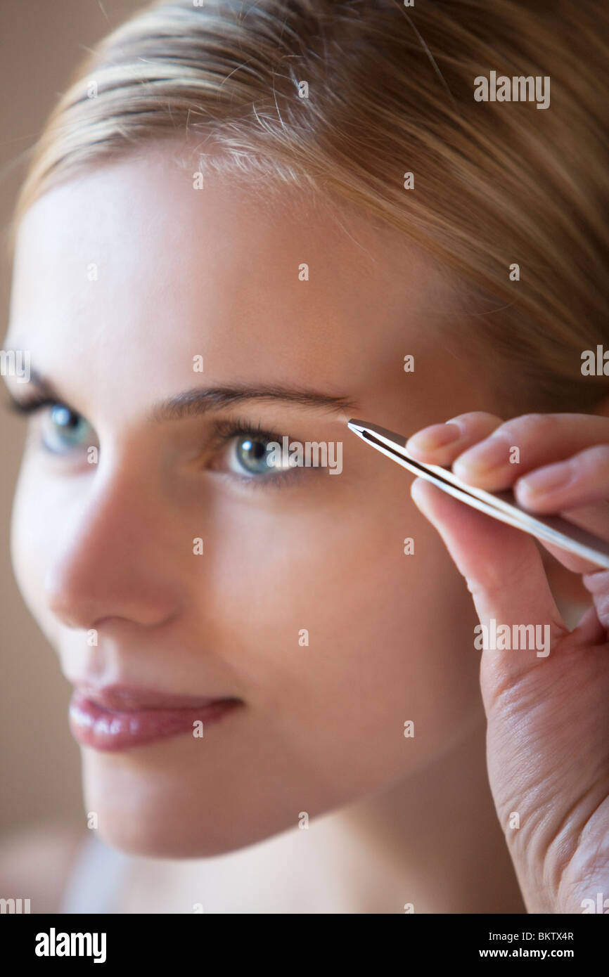 woman shaving her eyebrows Stock Photo Alamy