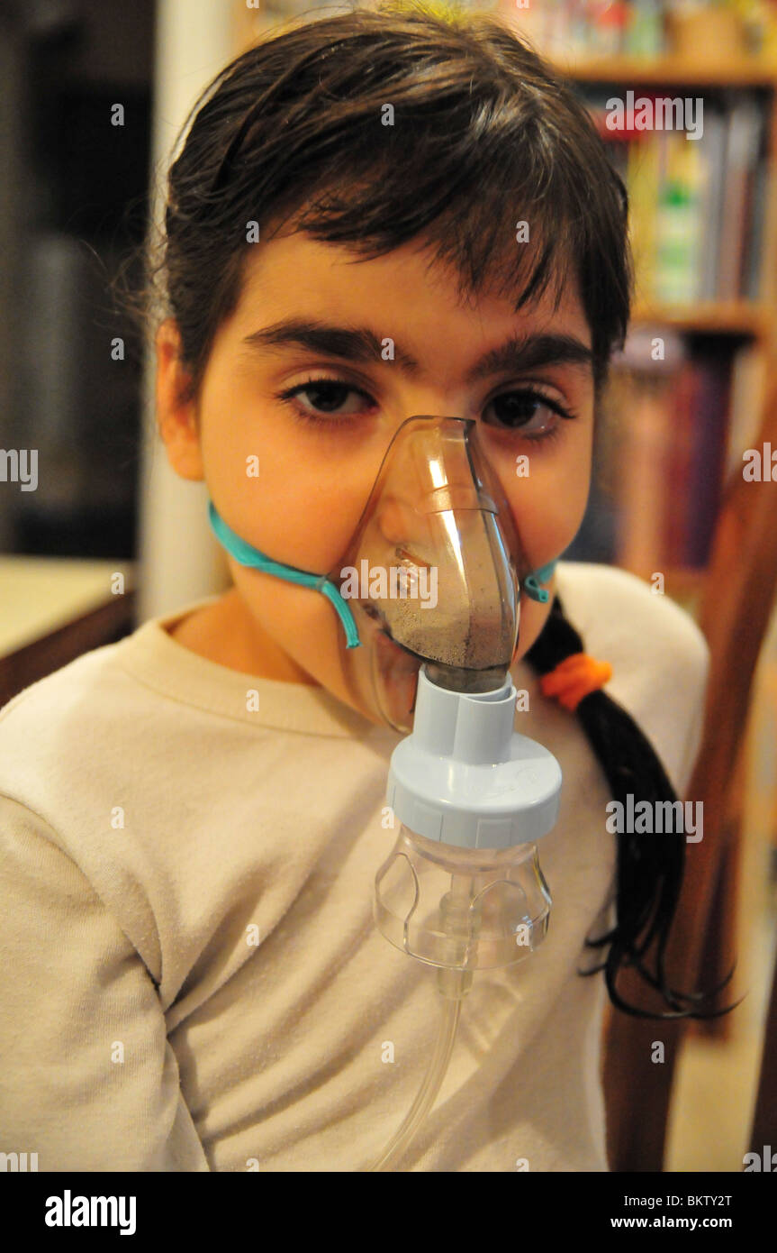 Health young girl of 8 suffers from Asthma oxygen humidifier inhaler