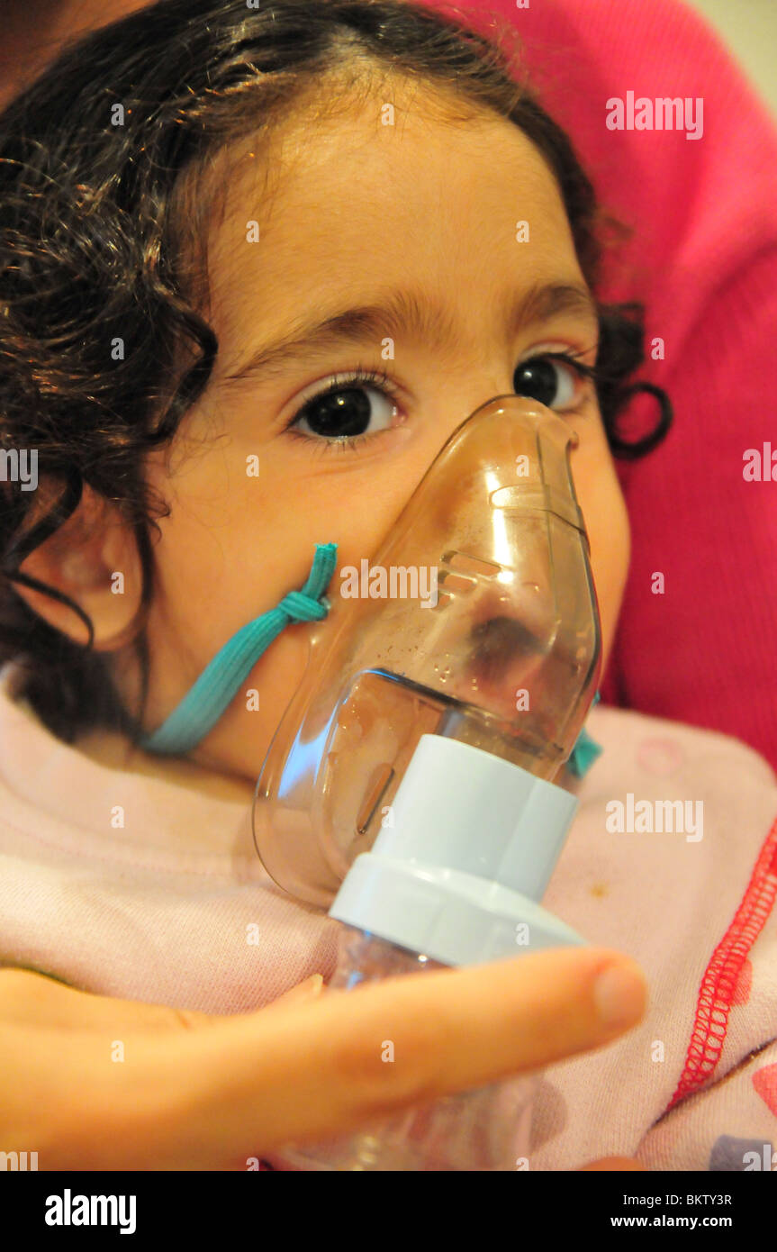 Health young girl of 3 suffers from Asthma oxygen humidifier inhaler