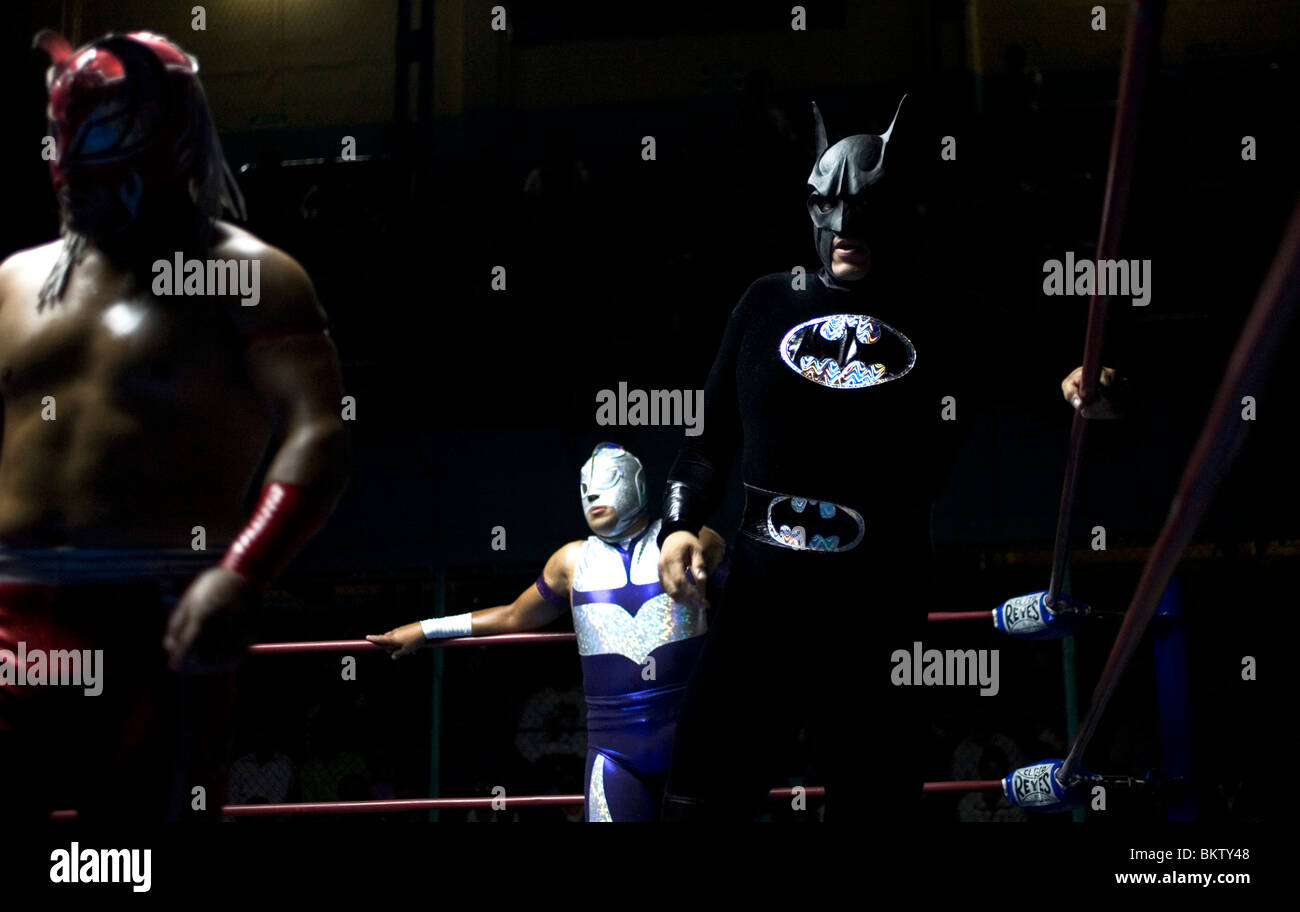 Wrestlers disguised as super heroes Astro Boy, left, Starman, center, and Batman at a wrestling event in Puebla, Mexico. Stock Photo