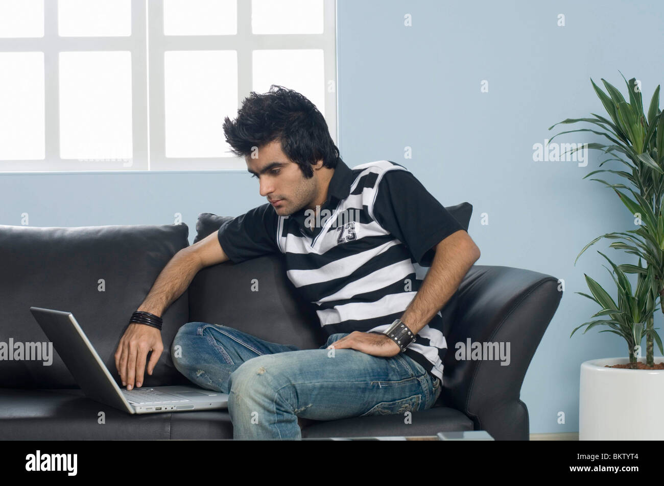 Indian man using laptop at home hi-res stock photography and images - Alamy