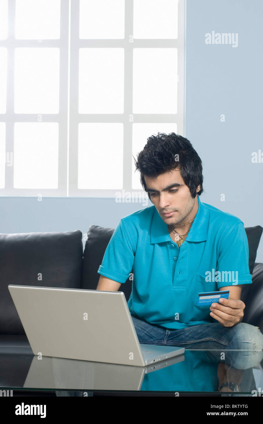 Young man holding credit card Stock Photo - Alamy