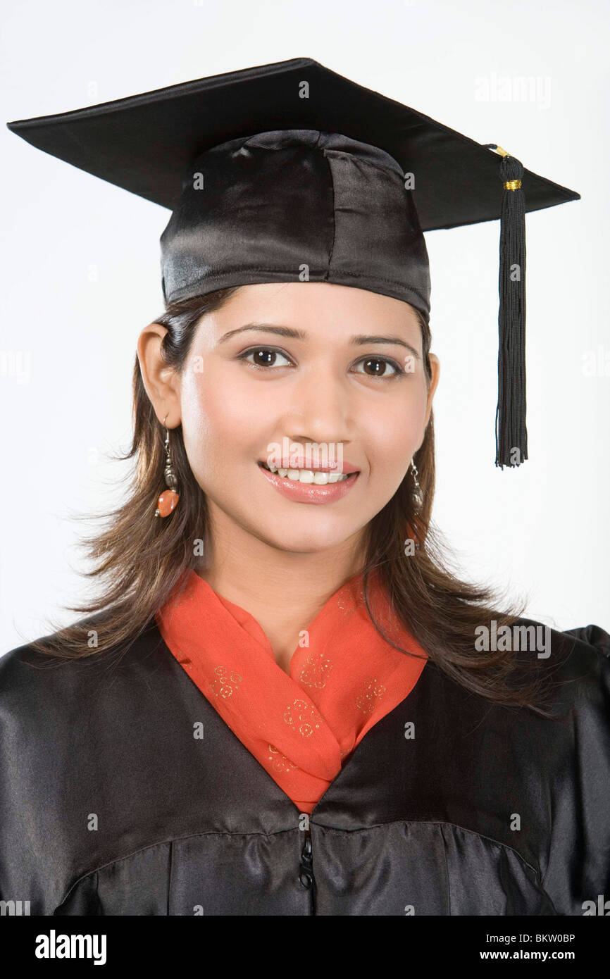 Young woman wearing mortar board, smiling, portrait Stock Photo