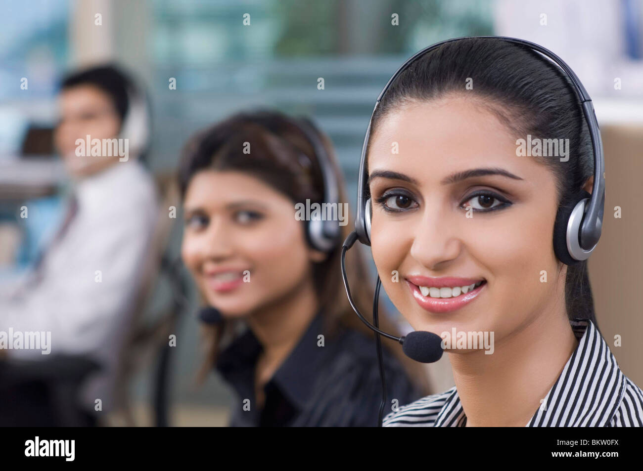 Businesswoman wearing headphone, smiling, portrait Stock Photo - Alamy