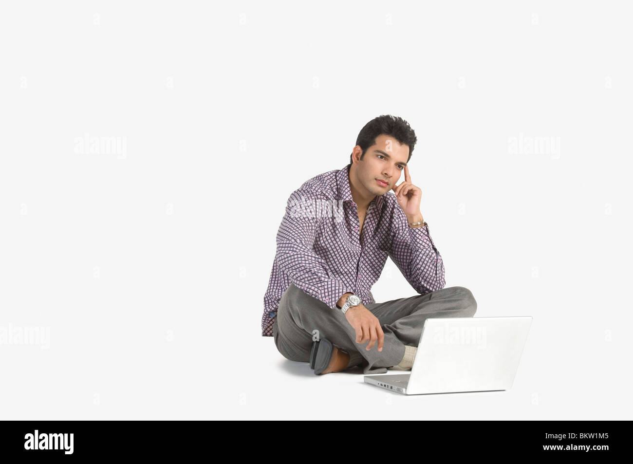 Indian man sitting cross legged Cut Out Stock Images & Pictures - Alamy