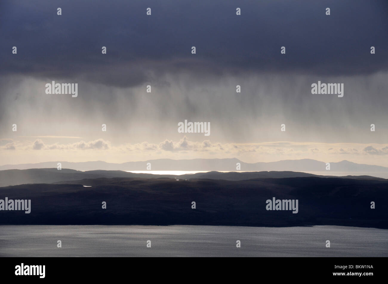 Dark rain clouds over Mull of Kintyre from Meall Bhig, Arran, Scotland Stock Photo