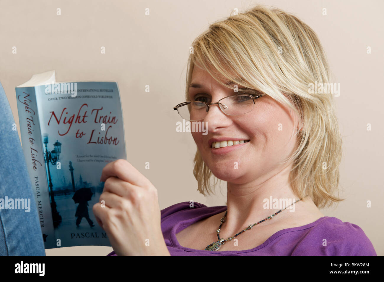Woman reading the International bestseller Night train to Lisbon by Pascal  Mercier Stock Photo - Alamy