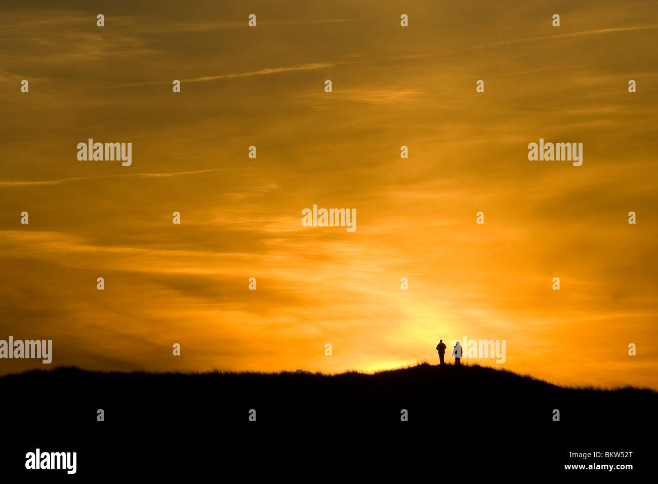 people watch the sunset on Ameland Stock Photo