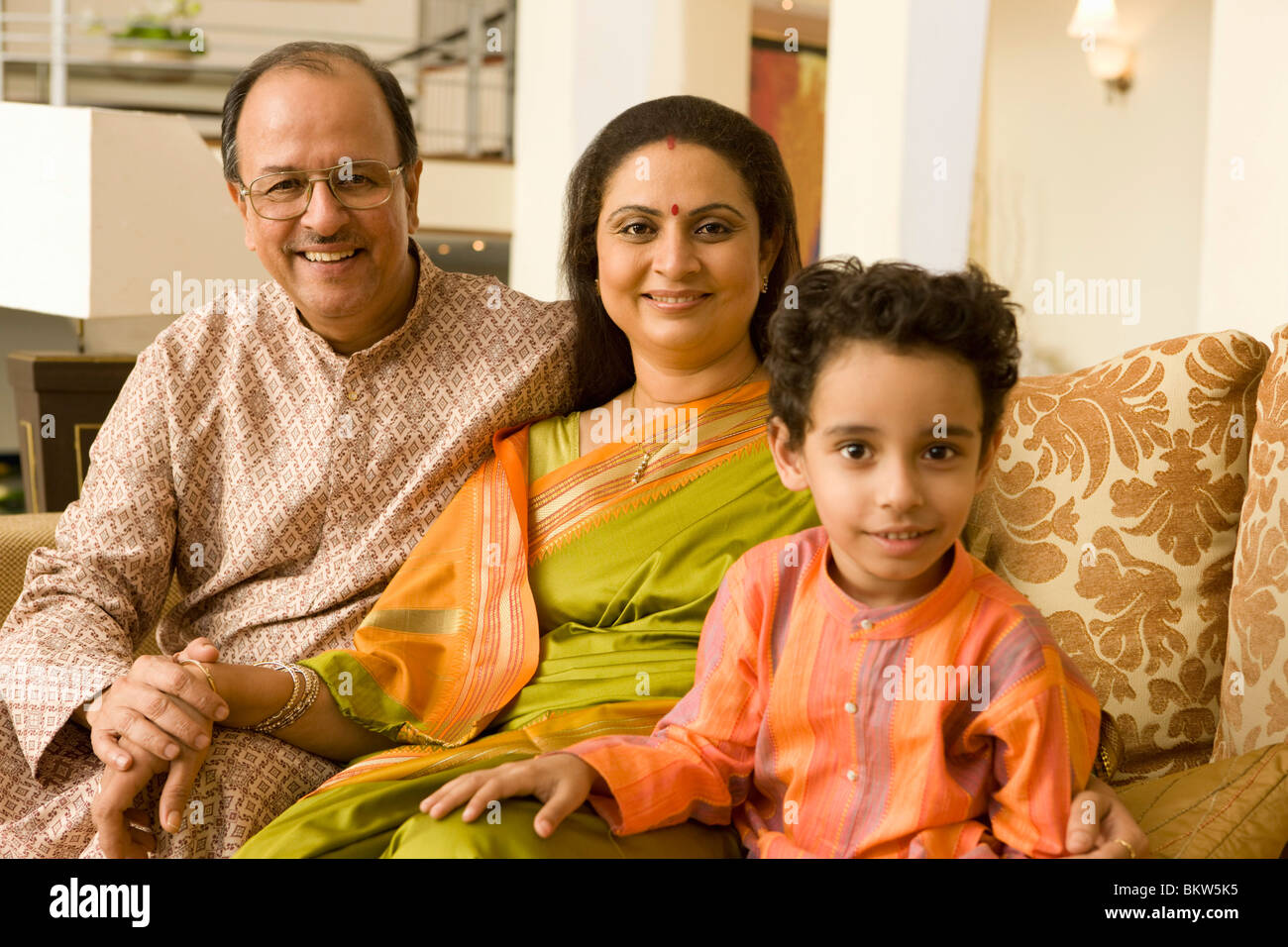 Grandparents with their grandson wearing traditional clothes sitting on