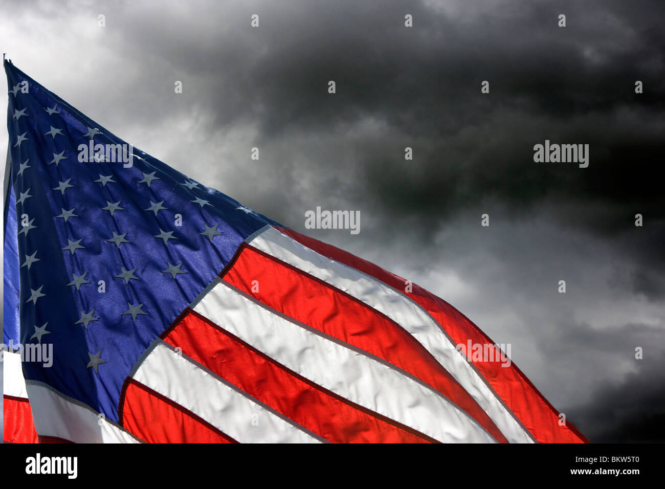 American Flag flies against Storm clouds Stock Photo Alamy