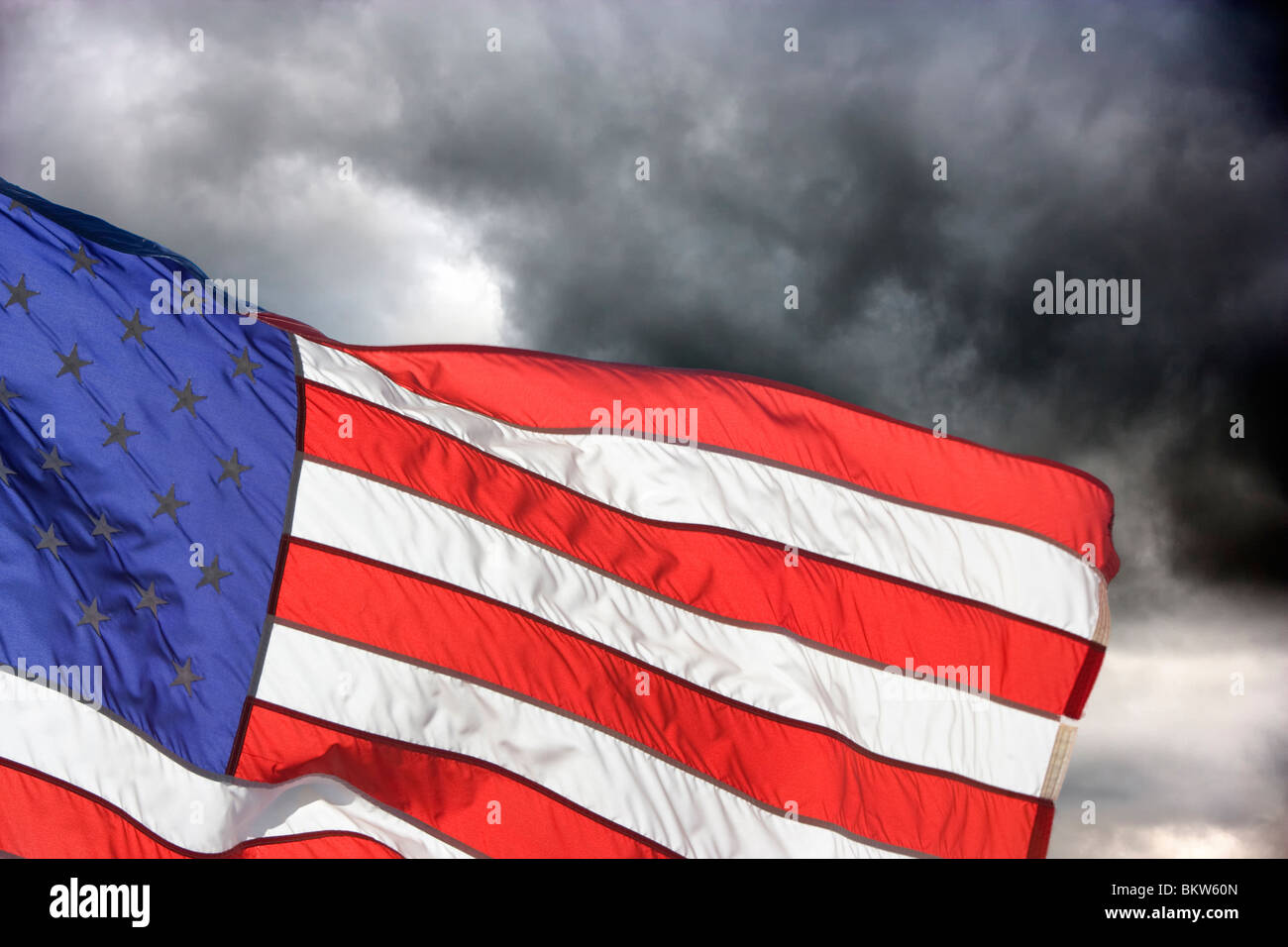 American Flag flies against Storm clouds Stock Photo Alamy