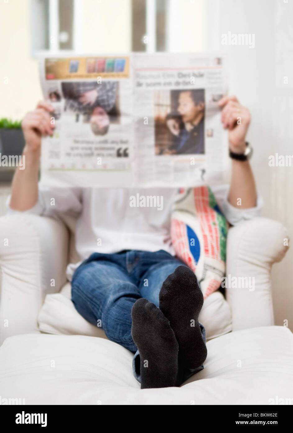 Man reading newspaper Stock Photo