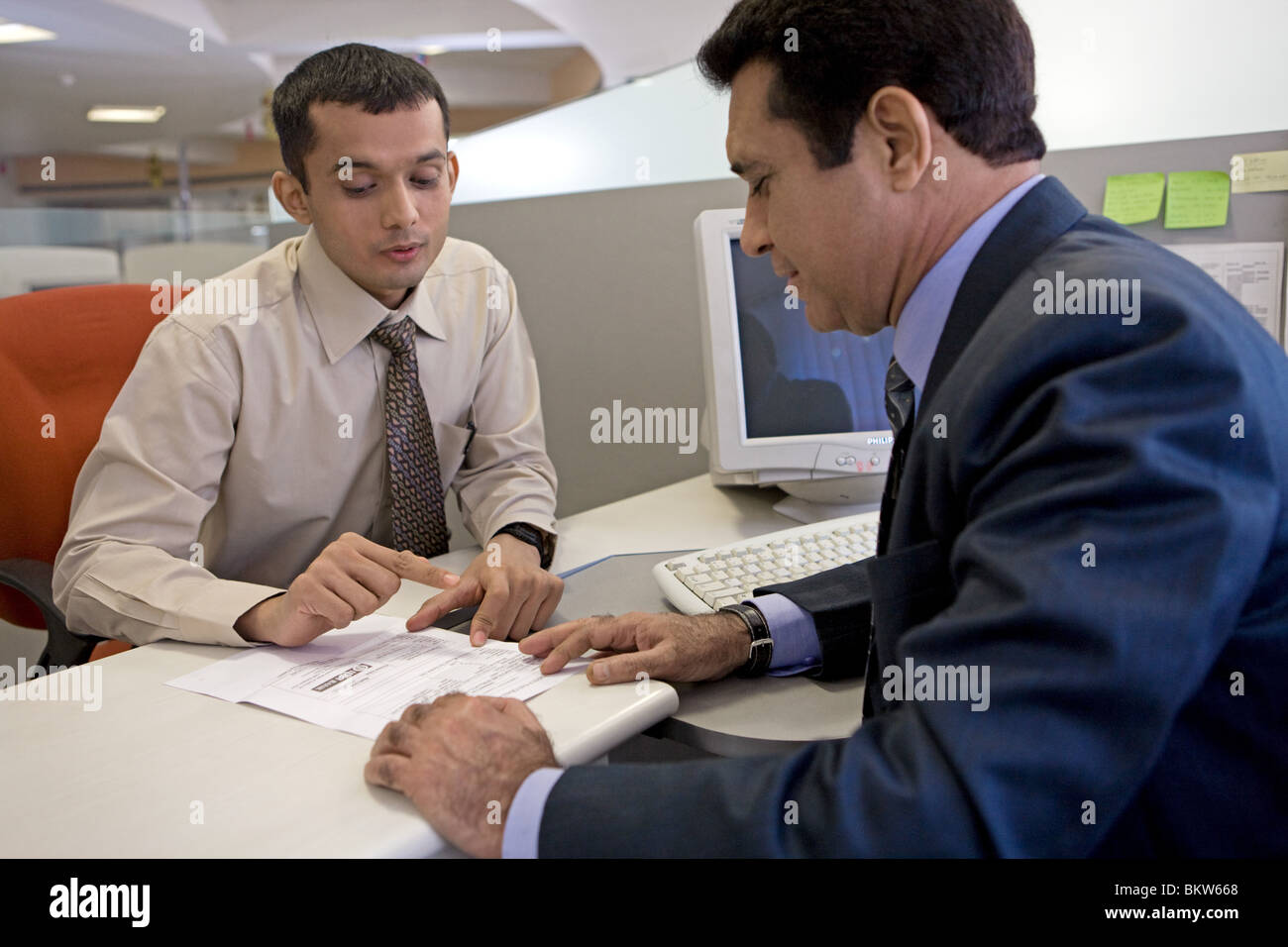 Two businessmen talking at the office Stock Photo - Alamy