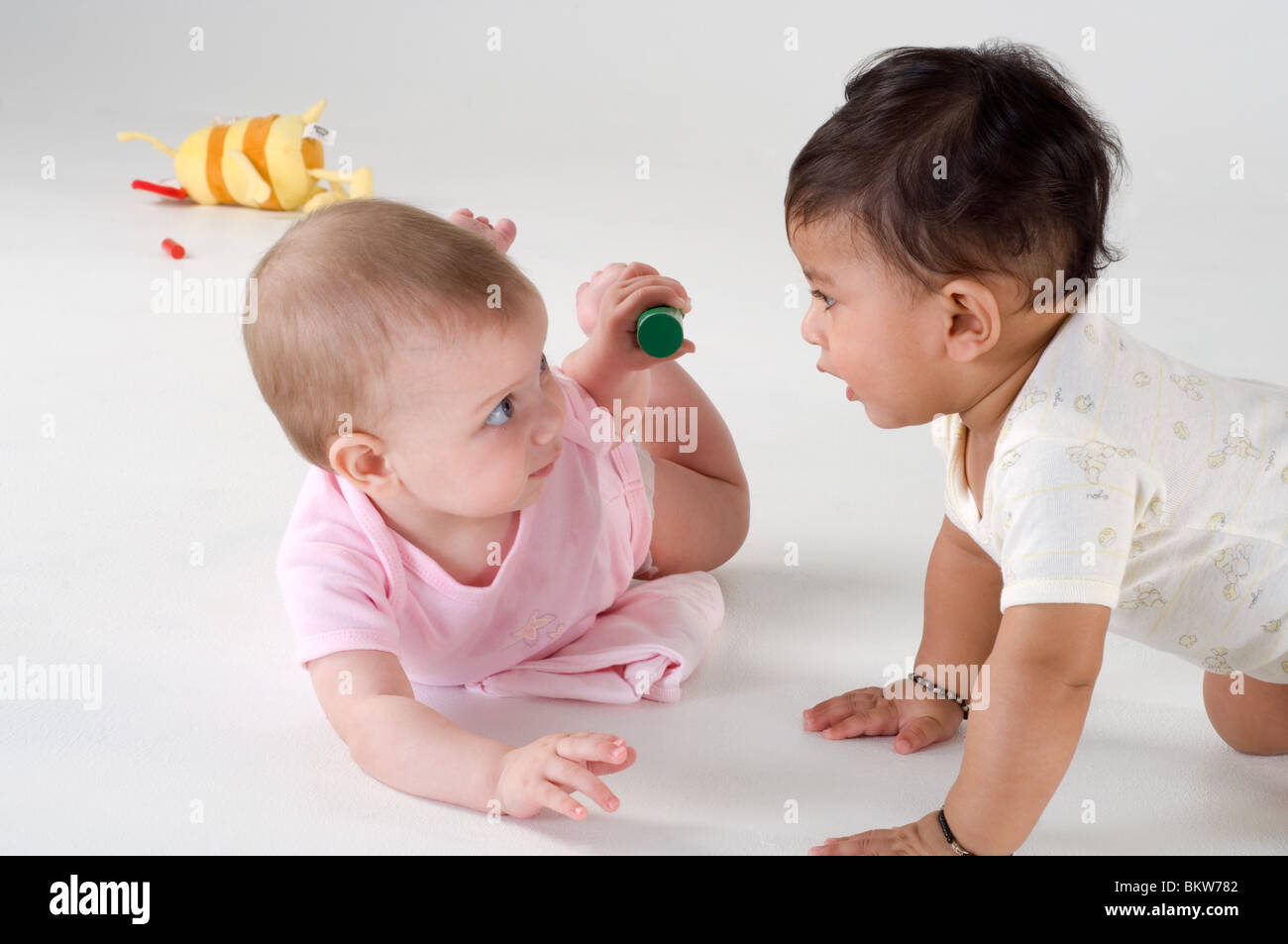 Two babies playing together Stock Photo - Alamy
