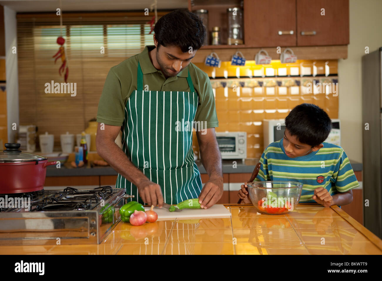 Father and son cooking in the kitchen Stock Photo Alamy