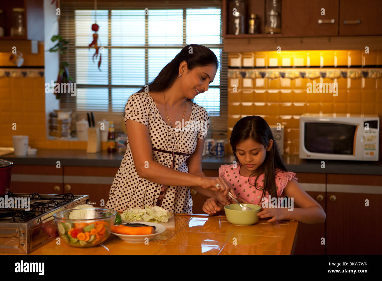 Mother and daughter cooking in the kitchen Stock Photo Alamy