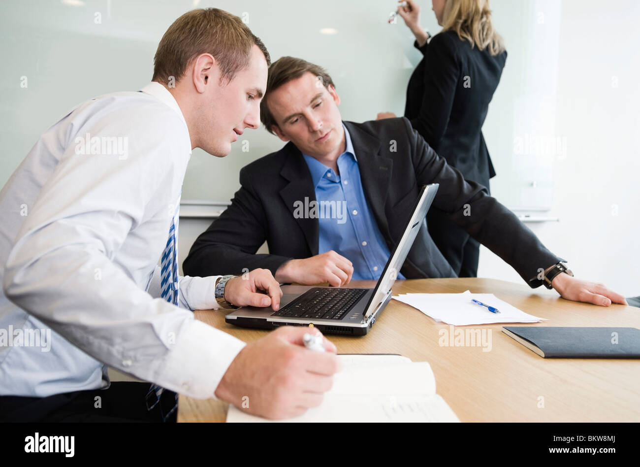 Two men and a woman in the conference room Stock Photo