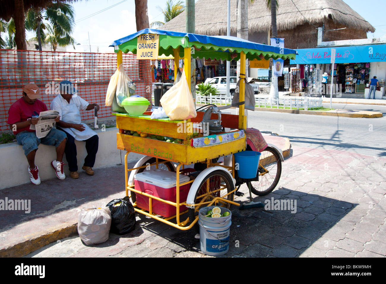 A freshly squeezed orange juice cart in the town on the island of Isla