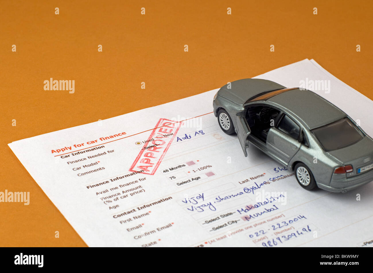 Toy car and application form Stock Photo - Alamy