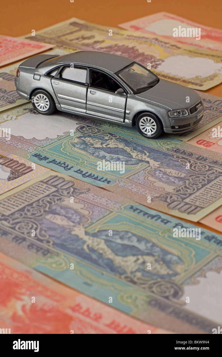 Toy car on top of indian rupee banknotes Stock Photo Alamy