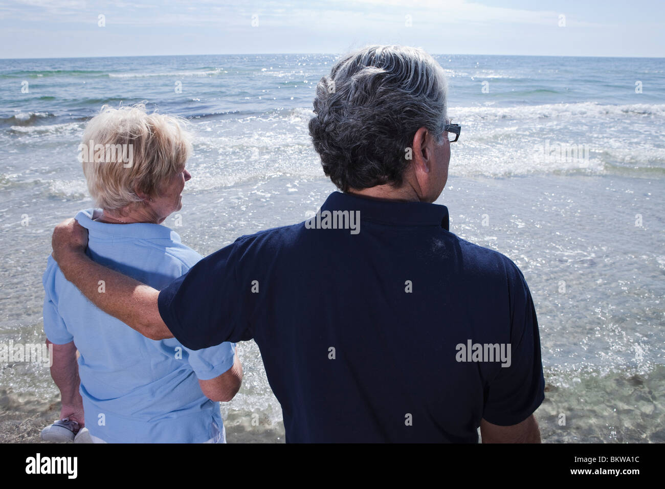 Man and woman looking out over water Stock Photo